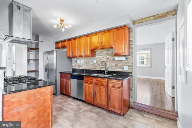 a kitchen with stainless steel appliances granite countertop a stove and a refrigerator