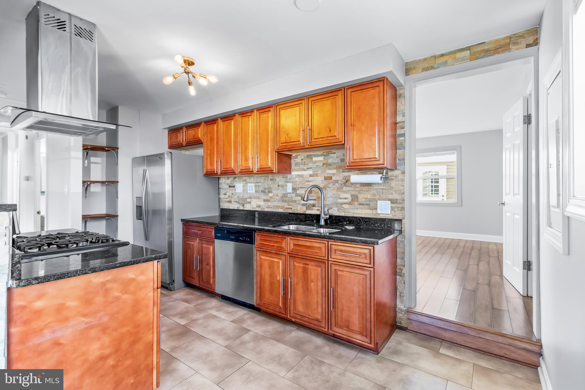 1000 8th Street Laurel, MD 20707 - Photo 8 of 45 a kitchen with stainless steel appliances granite countertop a stove and a refrigerator