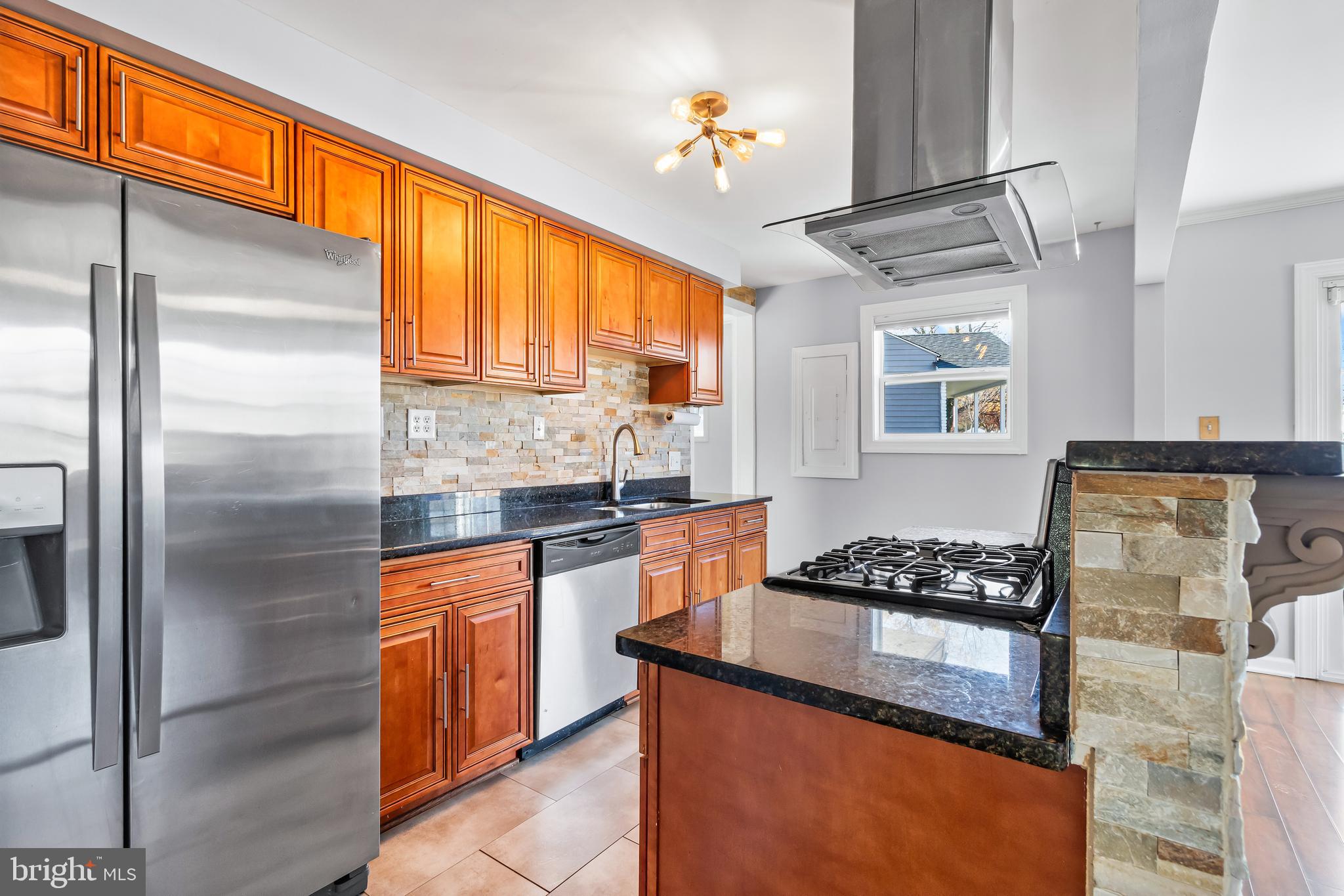 1000 8th Street Laurel, MD 20707 - Photo 9 of 45 a kitchen with stainless steel appliances granite countertop a refrigerator a sink dishwasher a stove and white countertops with wooden floor