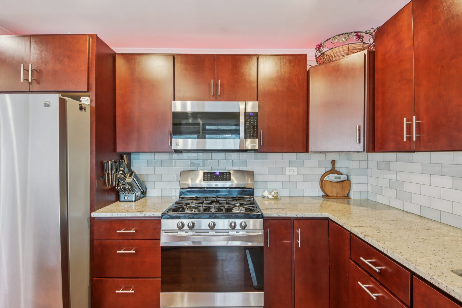4604 Maple Avenue Forest View, IL 60402 - Photo 11 of 35 a kitchen with stainless steel appliances wooden cabinets and a refrigerator