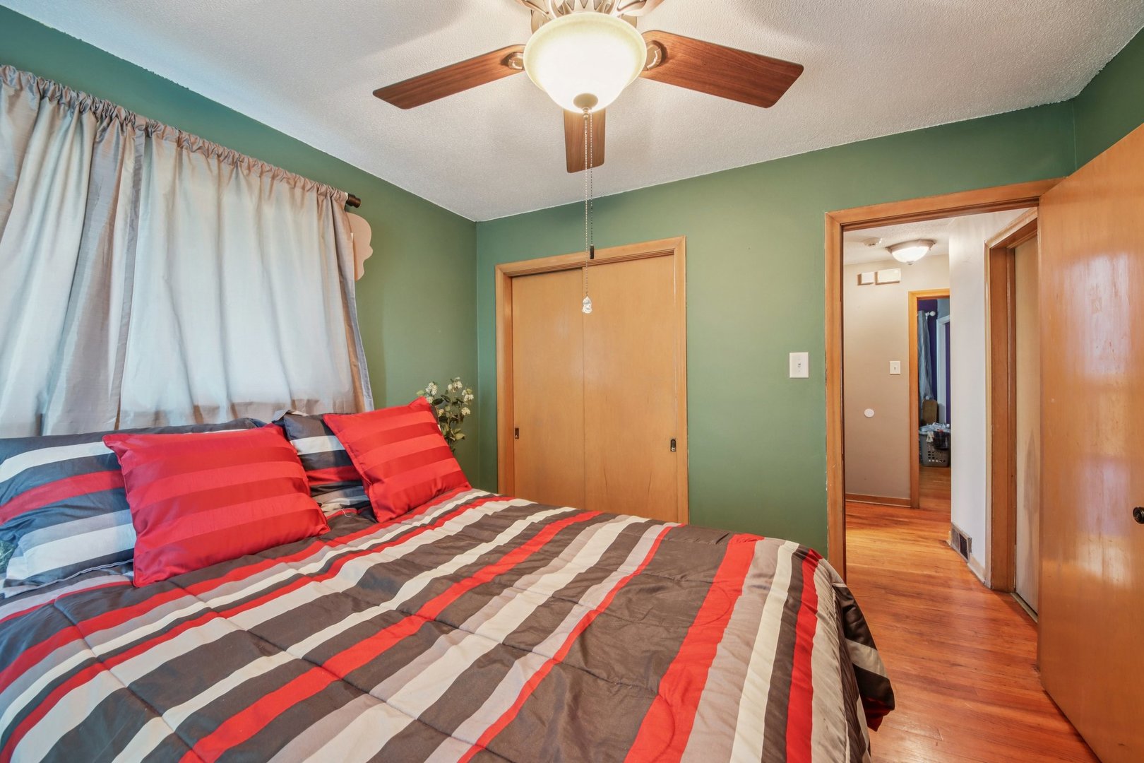 4604 Maple Avenue Forest View, IL 60402 - Photo 13 of 35 a bedroom with a bed and a chandelier