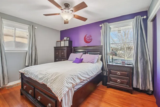 a bedroom with a bed dresser and a window