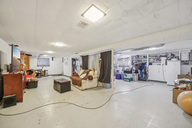 a living room with lots of furniture and gym equipment