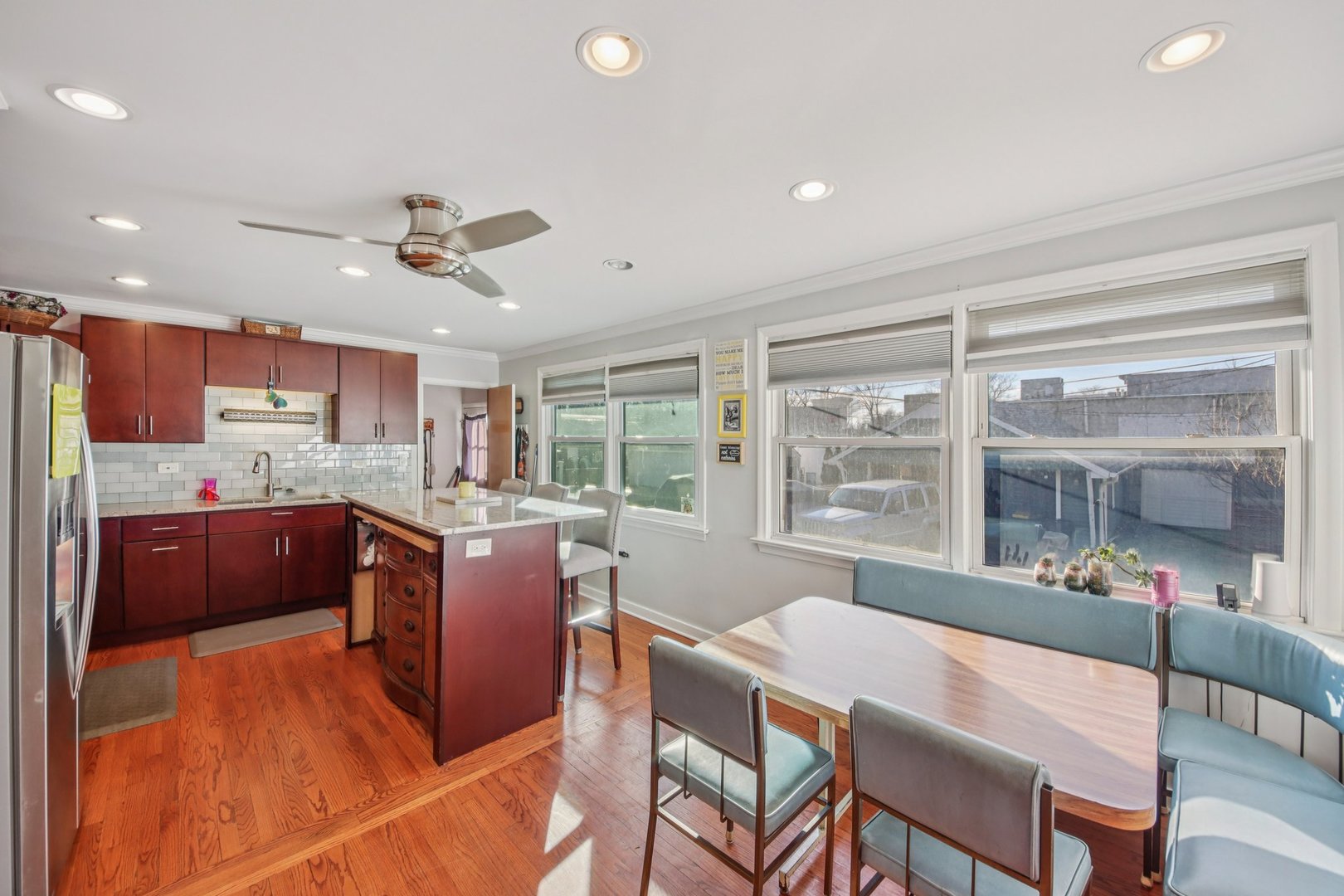 4604 Maple Avenue Forest View, IL 60402 - Photo 7 of 35 a open kitchen with stainless steel appliances granite countertop a refrigerator a sink dishwasher a stove and a dining table with wooden floor