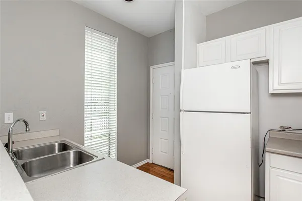 a white refrigerator freezer sitting inside of a kitchen