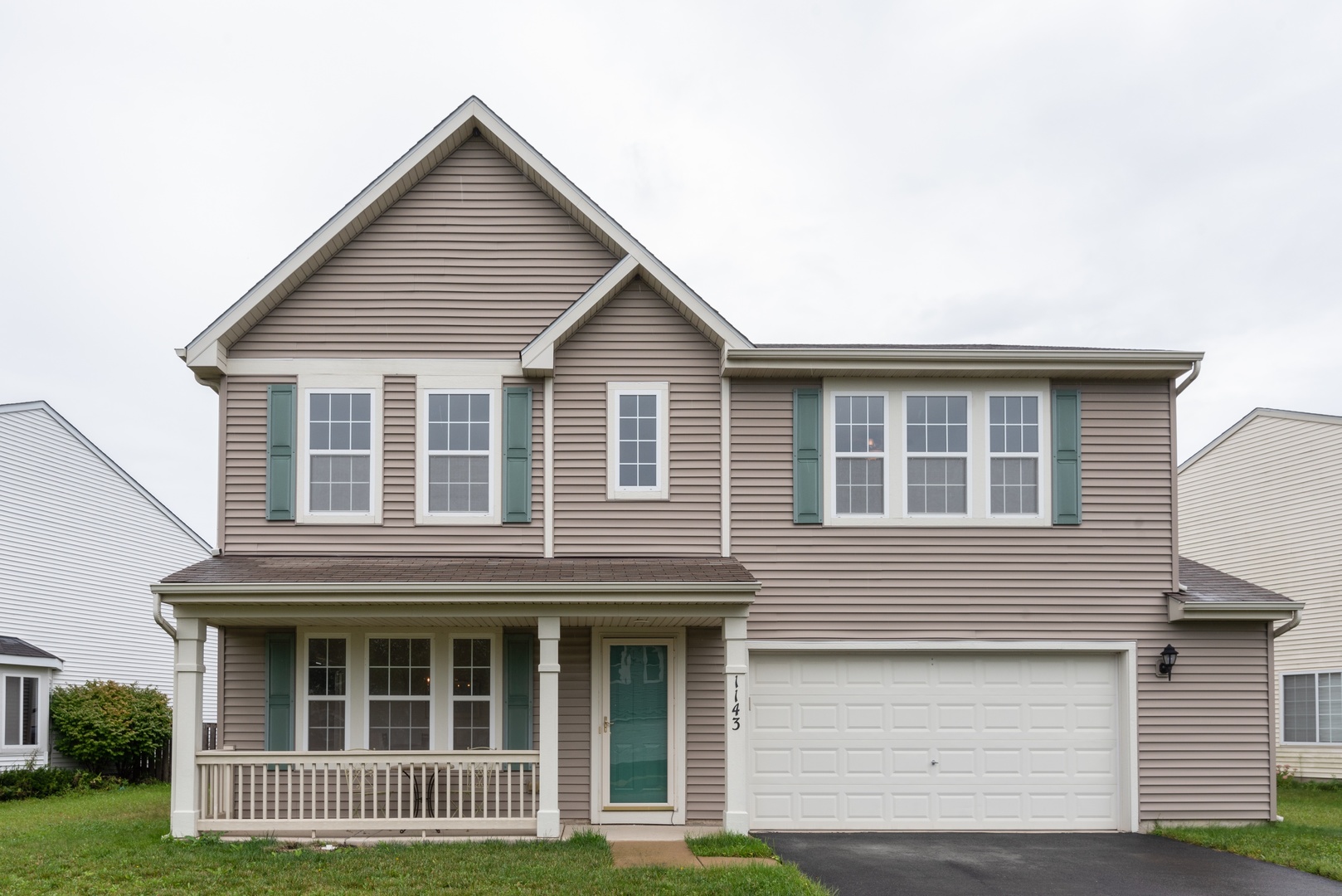 1143 Port Royal Road Pingree Grove, IL 60140 - Photo 1 of 13 a front view of a house with a garden
