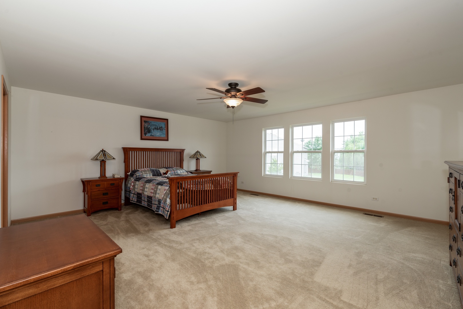 1143 Port Royal Road Pingree Grove, IL 60140 - Photo 7 of 13 a spacious bedroom with a bed and a ceiling fan