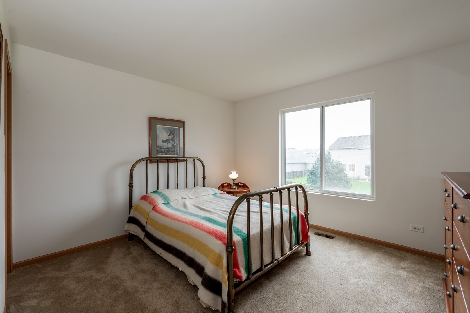 1143 Port Royal Road Pingree Grove, IL 60140 - Photo 9 of 13 a bed sitting in a bedroom next to a window