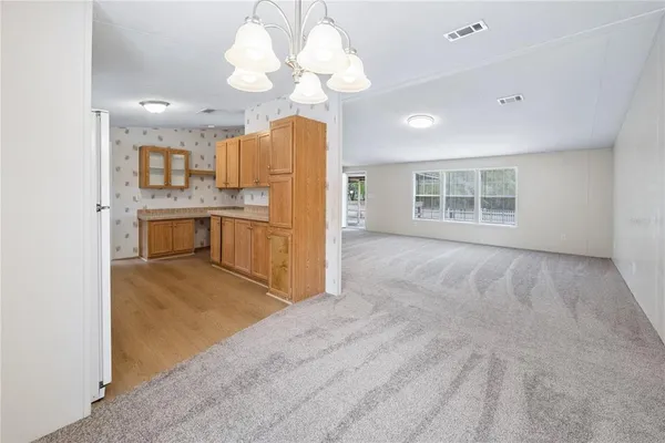 a view of a kitchen with a sink hardwood floor and a large window