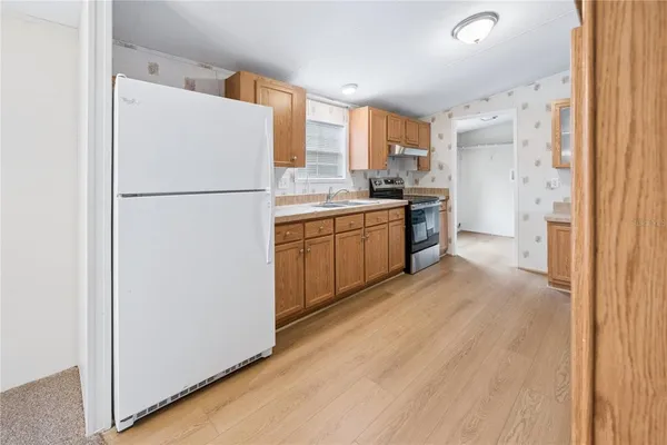 a kitchen with a refrigerator a sink and dishwasher