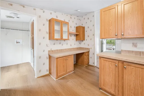 a view of a kitchen with cabinets and wooden floor