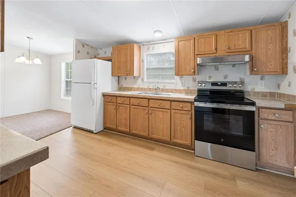 a kitchen with a stove a sink and a refrigerator