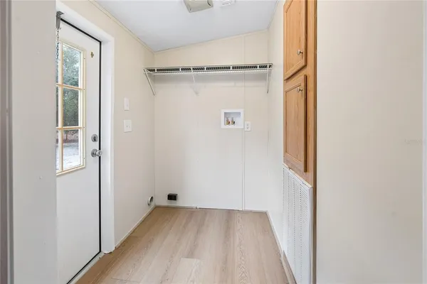a view of a room with wooden floor