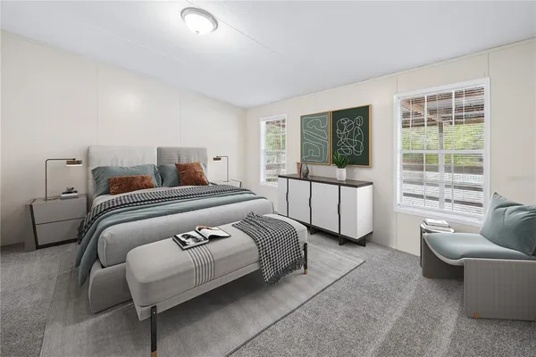 a bedroom with bed and a large window