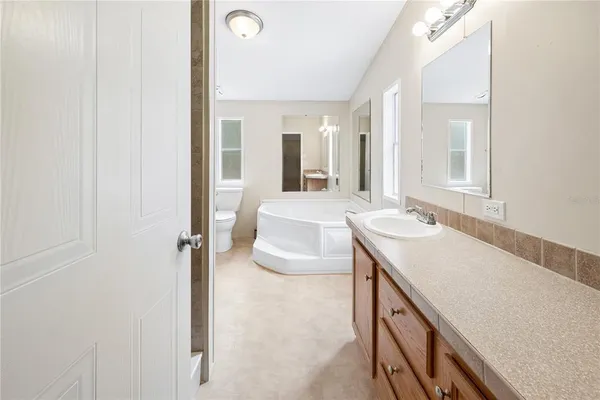 a white bath tub sitting next to a white toilet
