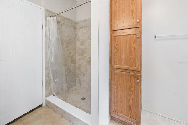 an empty room with a bathroom and mirror