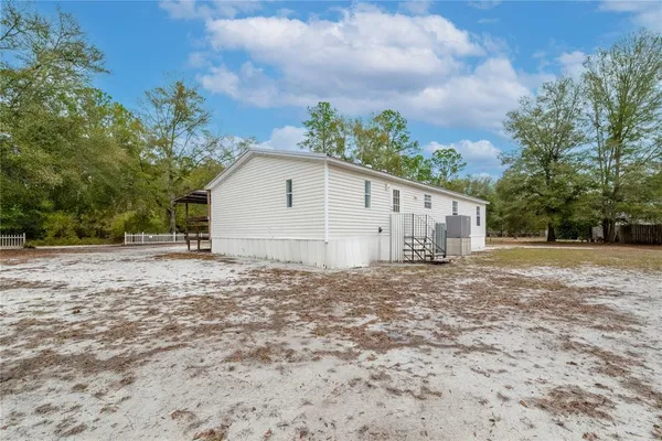 a view of a house with a yard and garage