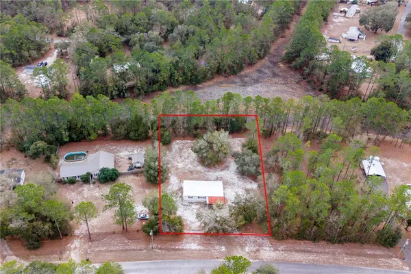 an aerial view of a house with a garden
