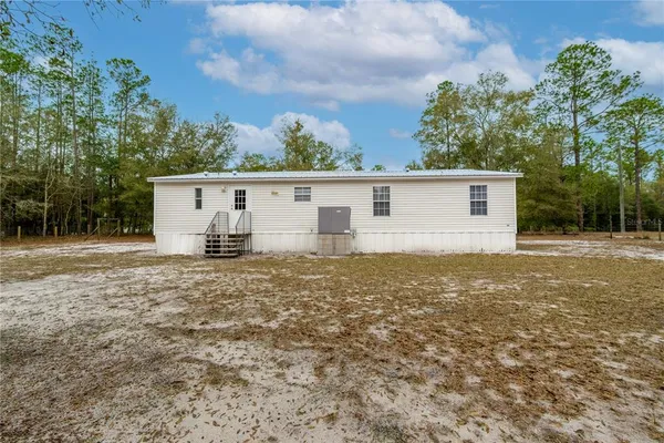 a view of a house with a backyard