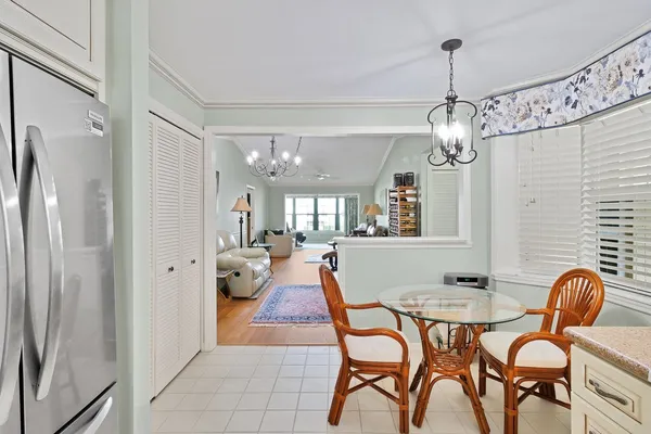 a view of a dining room with furniture wooden floor and chandelier
