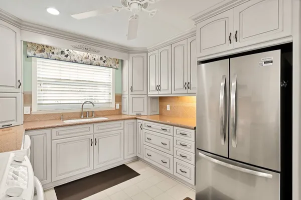 a kitchen with stainless steel appliances a refrigerator sink and cabinets