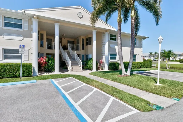 a view of a house with backyard and a tree