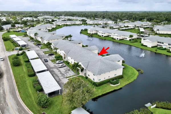 an aerial view of a house with a lake view