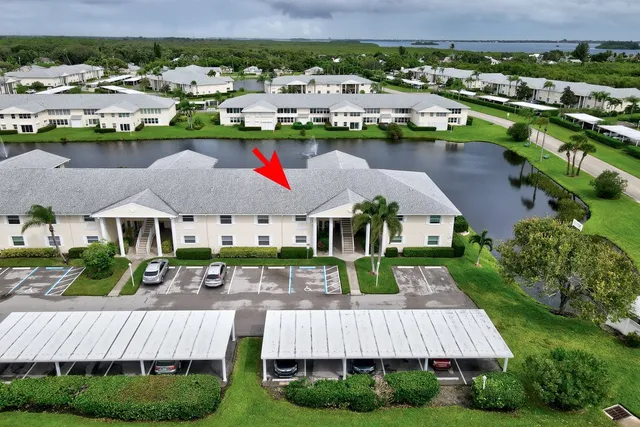 a view of a house with a yard and green space