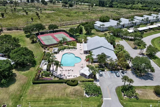an aerial view of a house with outdoor space swimming pool and lake view