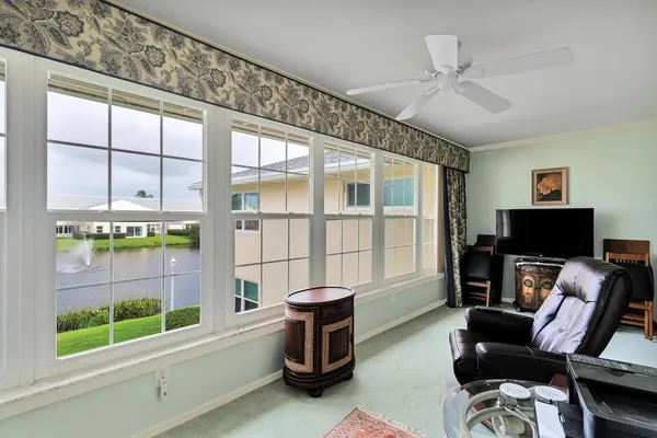 a living room with furniture a flat screen tv and a window
