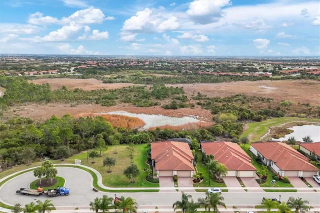 an aerial view of a house with outdoor space and lake view