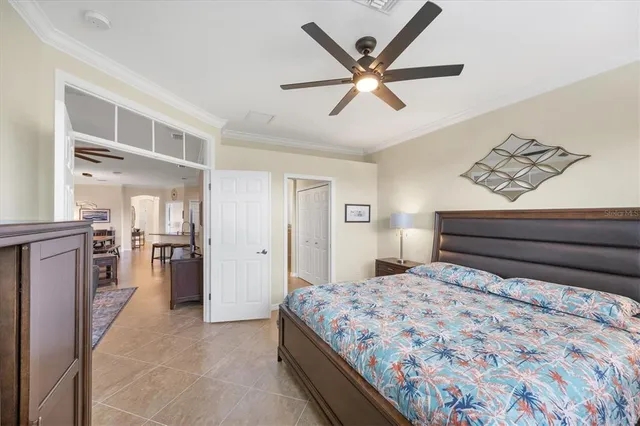 a room with lots of tables a large window and chairs