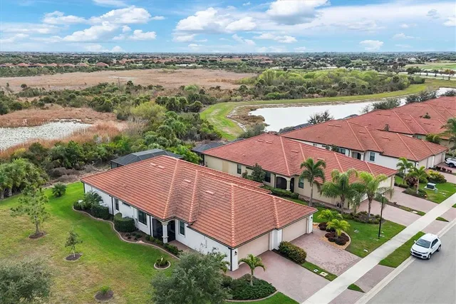 a view of a hallway with wooden floor and living room