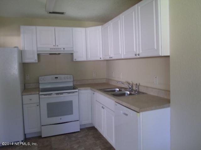 2516 Bayview Road Jacksonville, FL 32210 - Photo 4 of 8 a kitchen with granite countertop white cabinets stainless steel appliances and sink