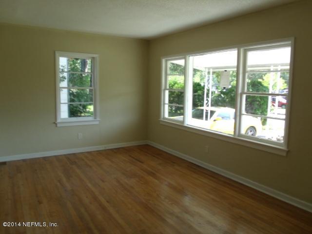 2516 Bayview Road Jacksonville, FL 32210 - Photo 6 of 8 a view of an empty room with wooden floor and a window