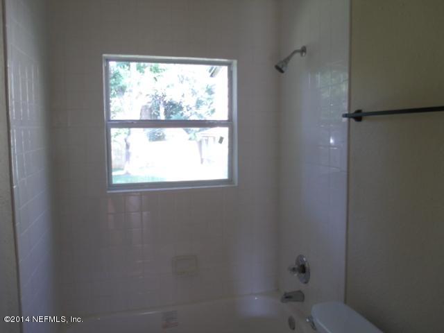 2516 Bayview Road Jacksonville, FL 32210 - Photo 7 of 8 a bathroom with a window