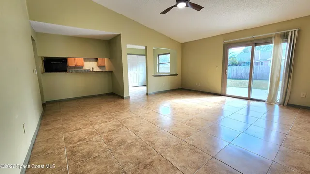 a kitchen with granite countertop a stove a sink and a refrigerator