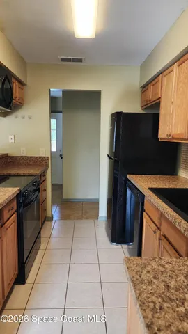 a kitchen with a sink cabinets and stainless steel appliances