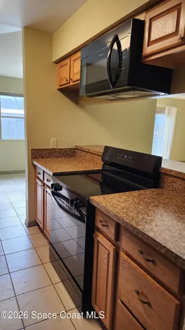 a kitchen with granite countertop a stove and a sink