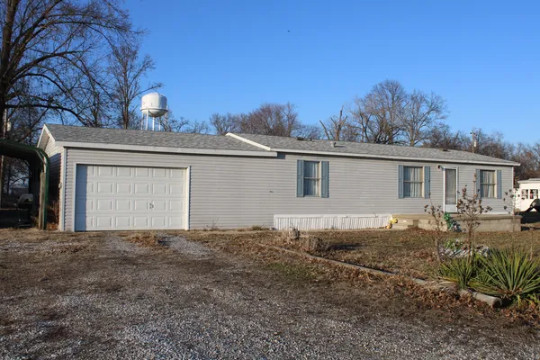 a view of a backyard with wooden floor and outdoor seating