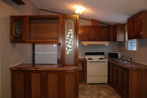 a kitchen with a stove and a refrigerator