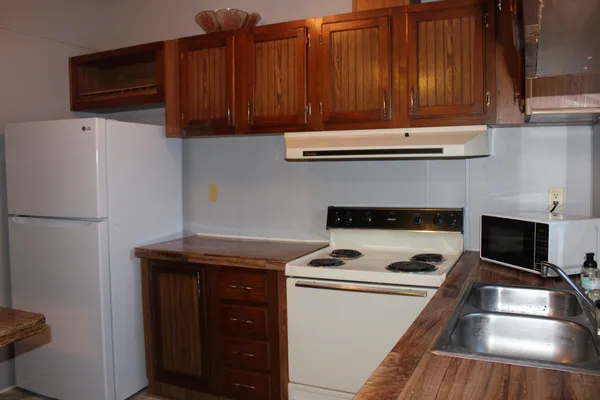 a kitchen with a stove and a refrigerator
