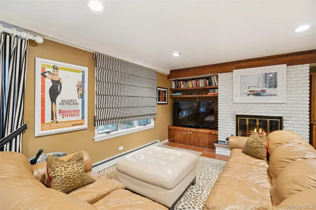 a living room with furniture a flat screen tv and a fireplace