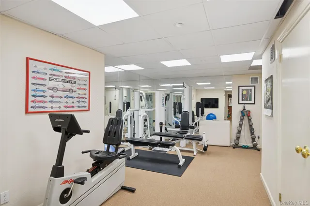 a room with gym equipment and view of living room