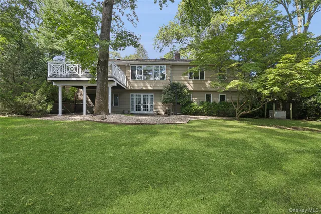 a view of house with a yard