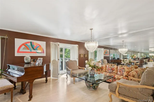 a living room with furniture and a chandelier