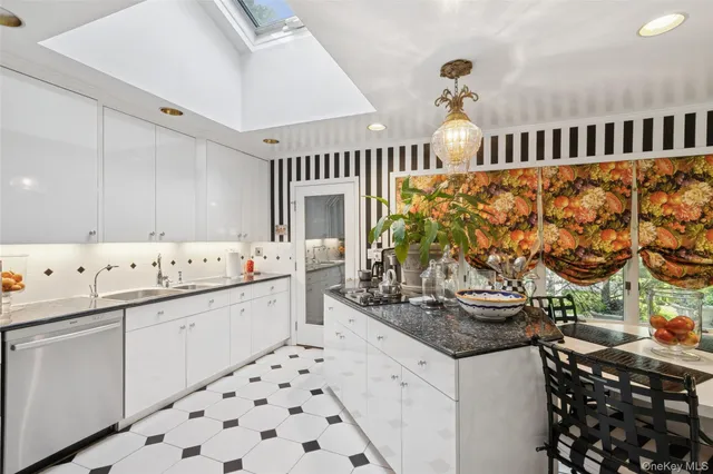 a kitchen with stainless steel appliances a sink and cabinets