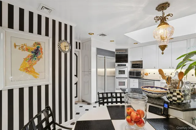 a kitchen with stainless steel appliances a refrigerator and a stove top oven