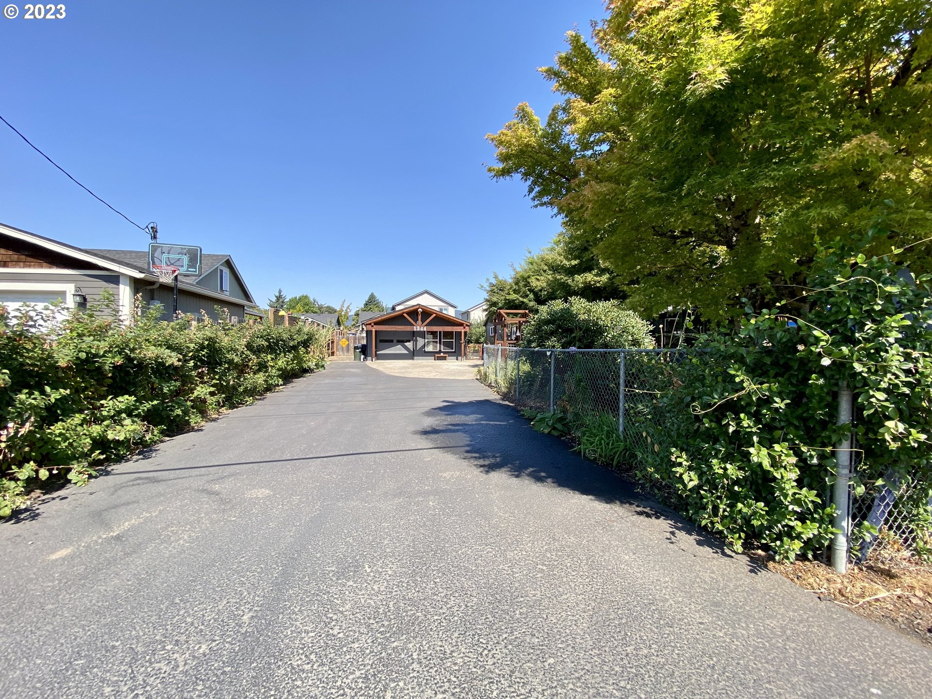 1344 S Street Springfield, OR 97477 - Photo 12 of 30 a view of a street with potted plants and big trees