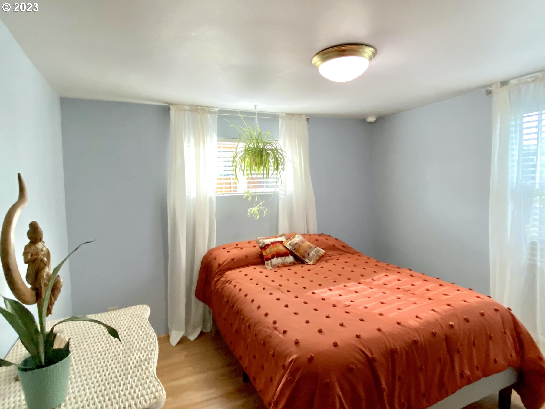 1344 S Street Springfield, OR 97477 - Photo 25 of 30 a bedroom with a bed and a chandelier